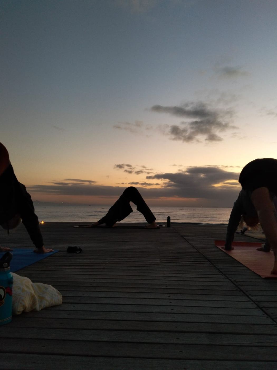 Downward dog on the deck facing the ocean