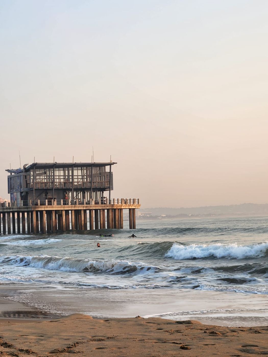 Waves rolling in by the pier